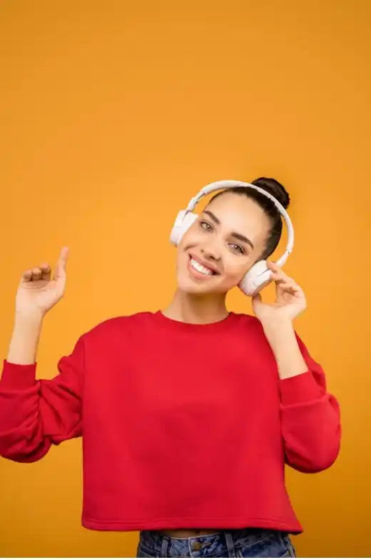 Smiling woman in a red sweatshirt and headphones
