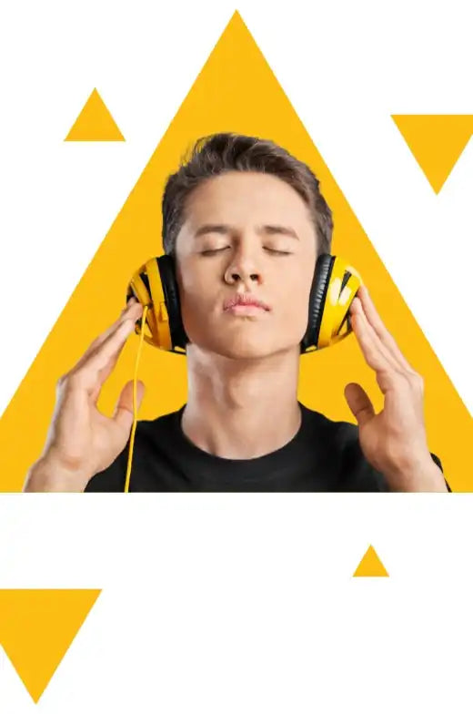 A young man wearing yellow and black over-ear headphones, with his eyes closed in enjoyment.